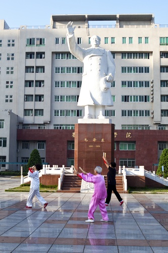 Dancing in front of Chairman Mao statue