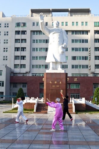 Dancing in front of Chairman Mao statue